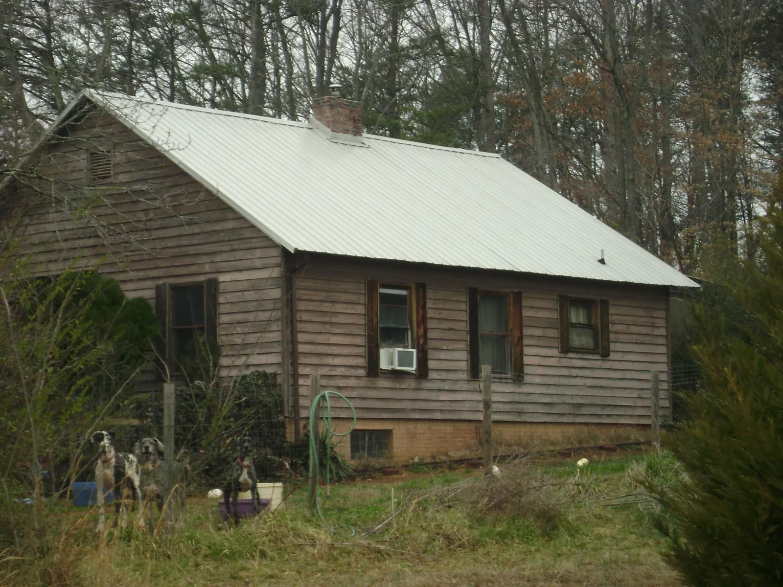 White metal roof on an old wood sided farmhouse, from a Metal Roof Installation job in Westfield